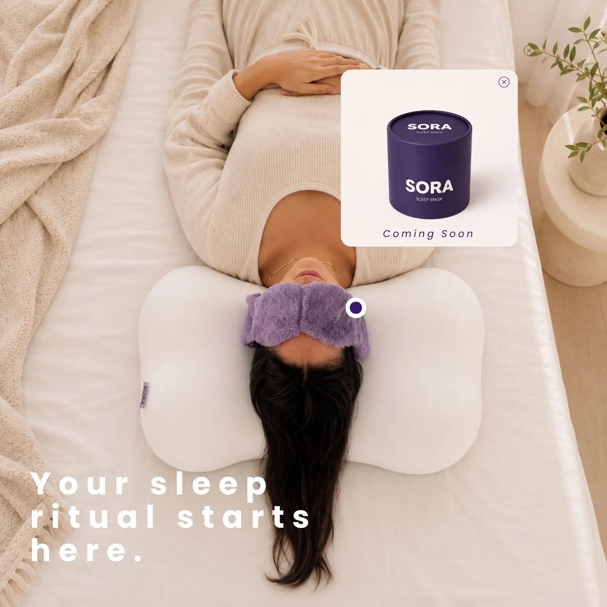 Woman resting on SORA Cloud ergonomic pillow wearing a sleep mask — SORA sleep wellness brand lifestyle image