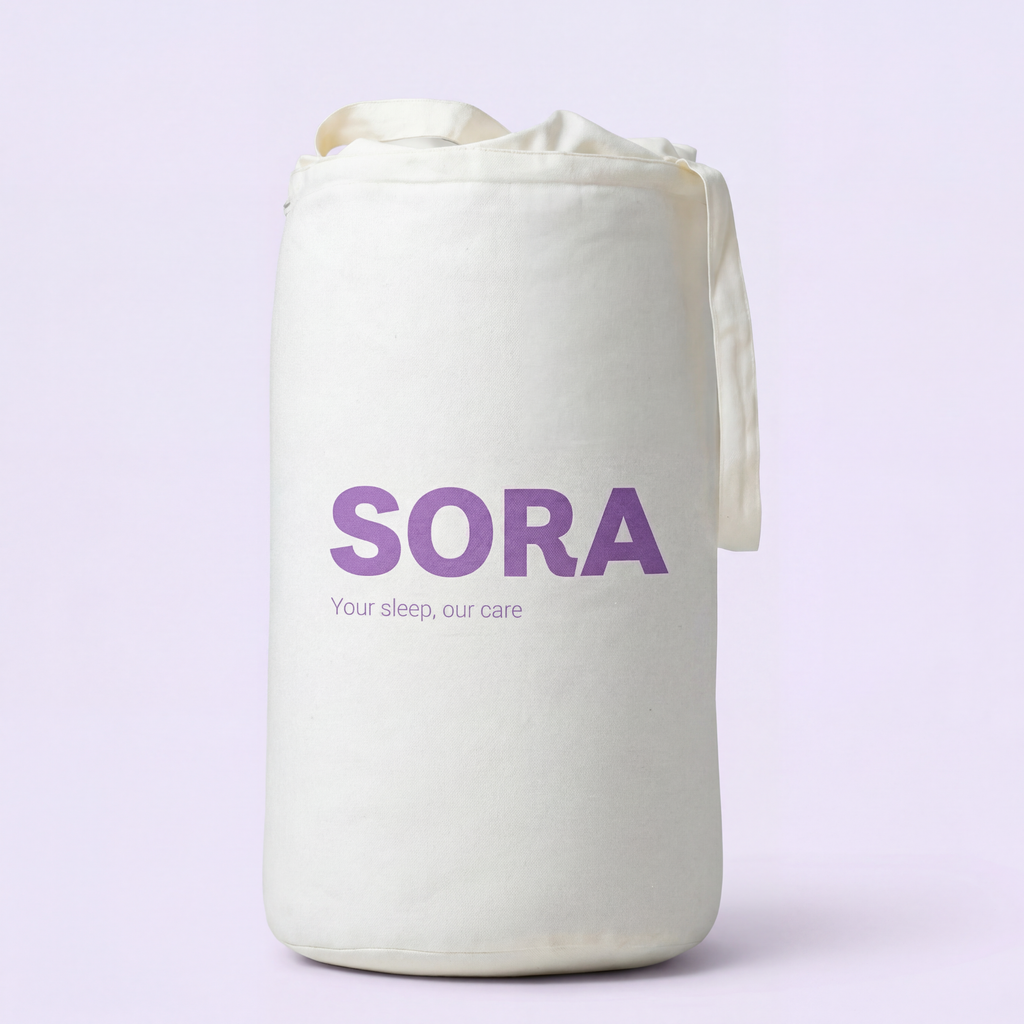 SORA Cloud ergonomic pillow shown from above on blush pink background with orange annotation arrows pointing to two zones. Soft Side for Back Sleepers at the top and Cervical Channel for Side Sleepers at the bottom