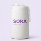 SORA Cloud ergonomic pillow shown from above on blush pink background with orange annotation arrows pointing to two zones. Soft Side for Back Sleepers at the top and Cervical Channel for Side Sleepers at the bottom